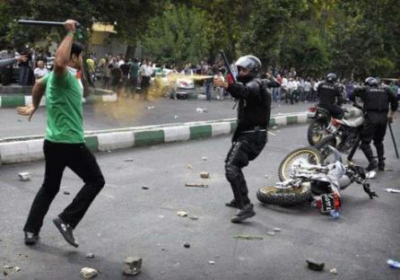 A supporter of Moussavi fighting the Basiji - militia